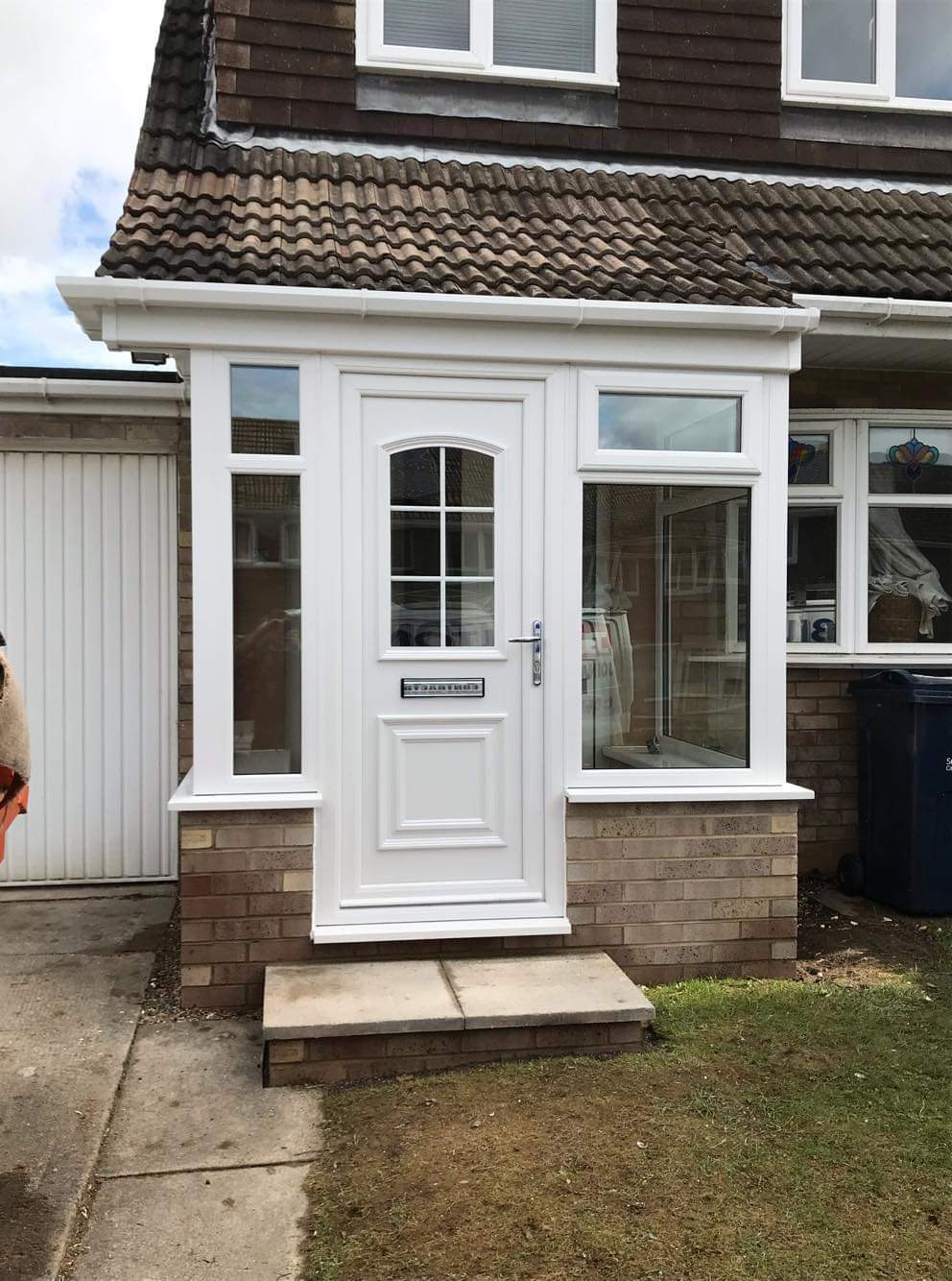 A new UPVC front porch with a panelled door