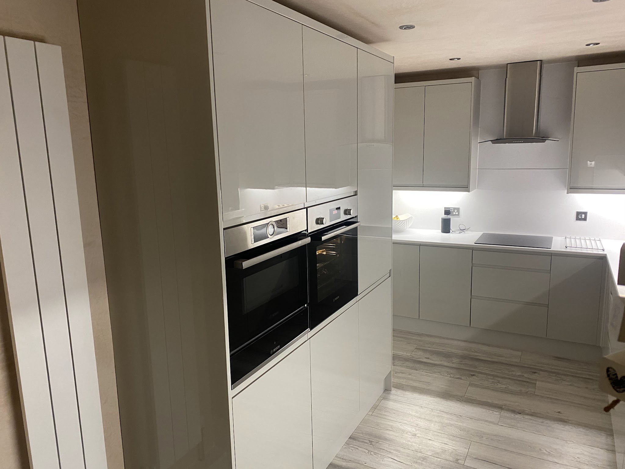 A fitted handleless kitchen with built-in ovens